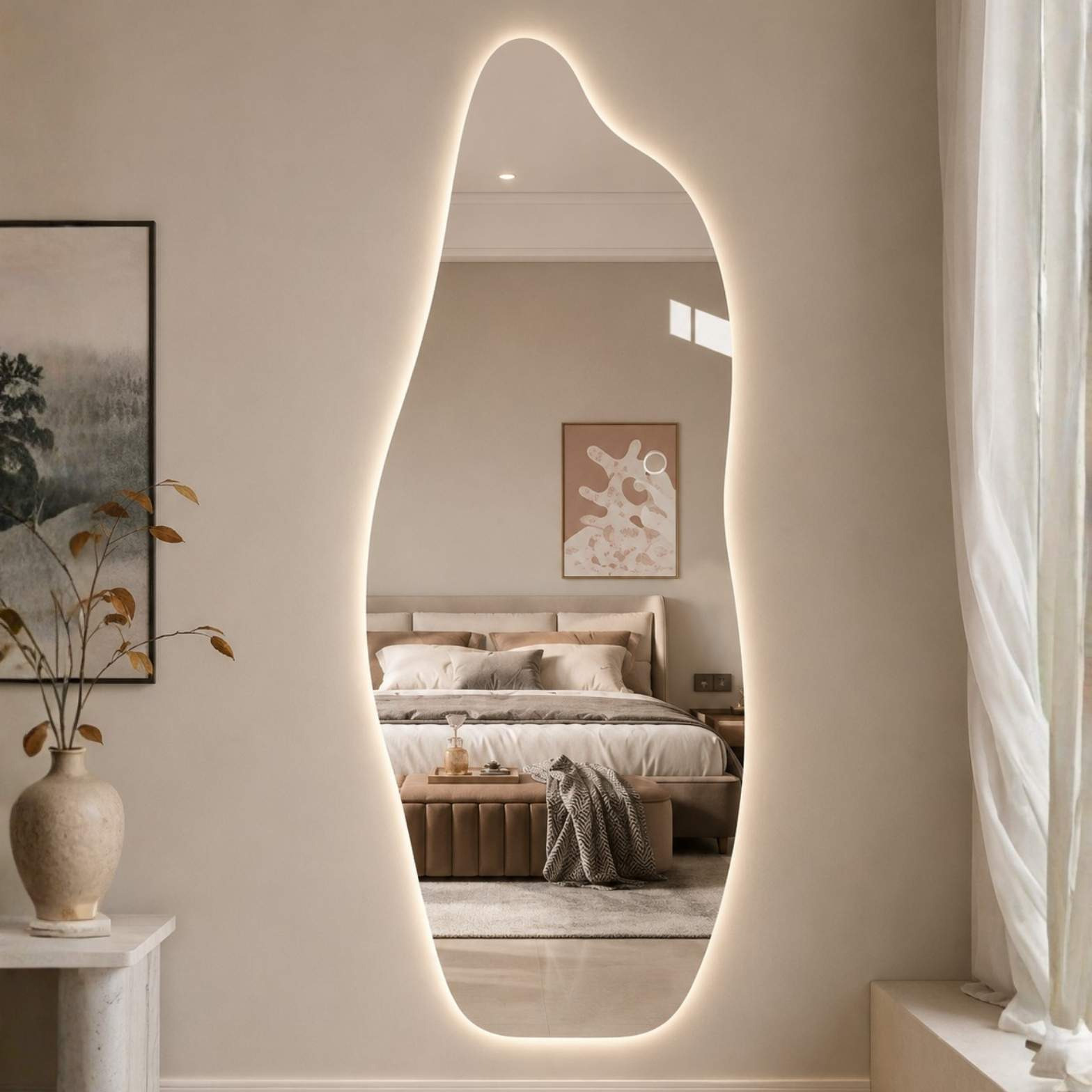 An asymmetrical, full-length floor mirror with a glowing backlit border reflecting a neutral-toned luxury bedroom.
