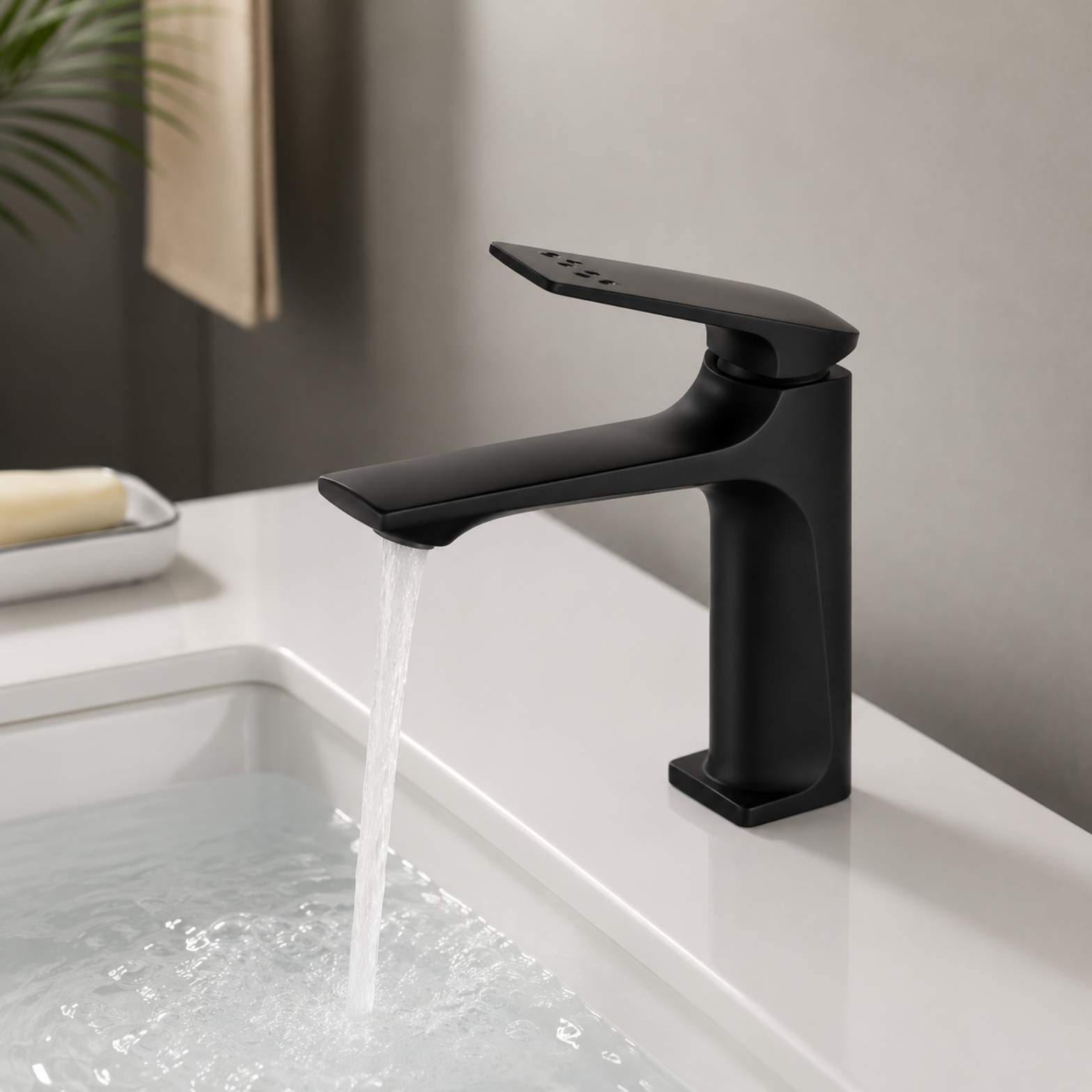 A premium matte black single-handle faucet running water into a white integrated undermount sink from alwakil.ae 