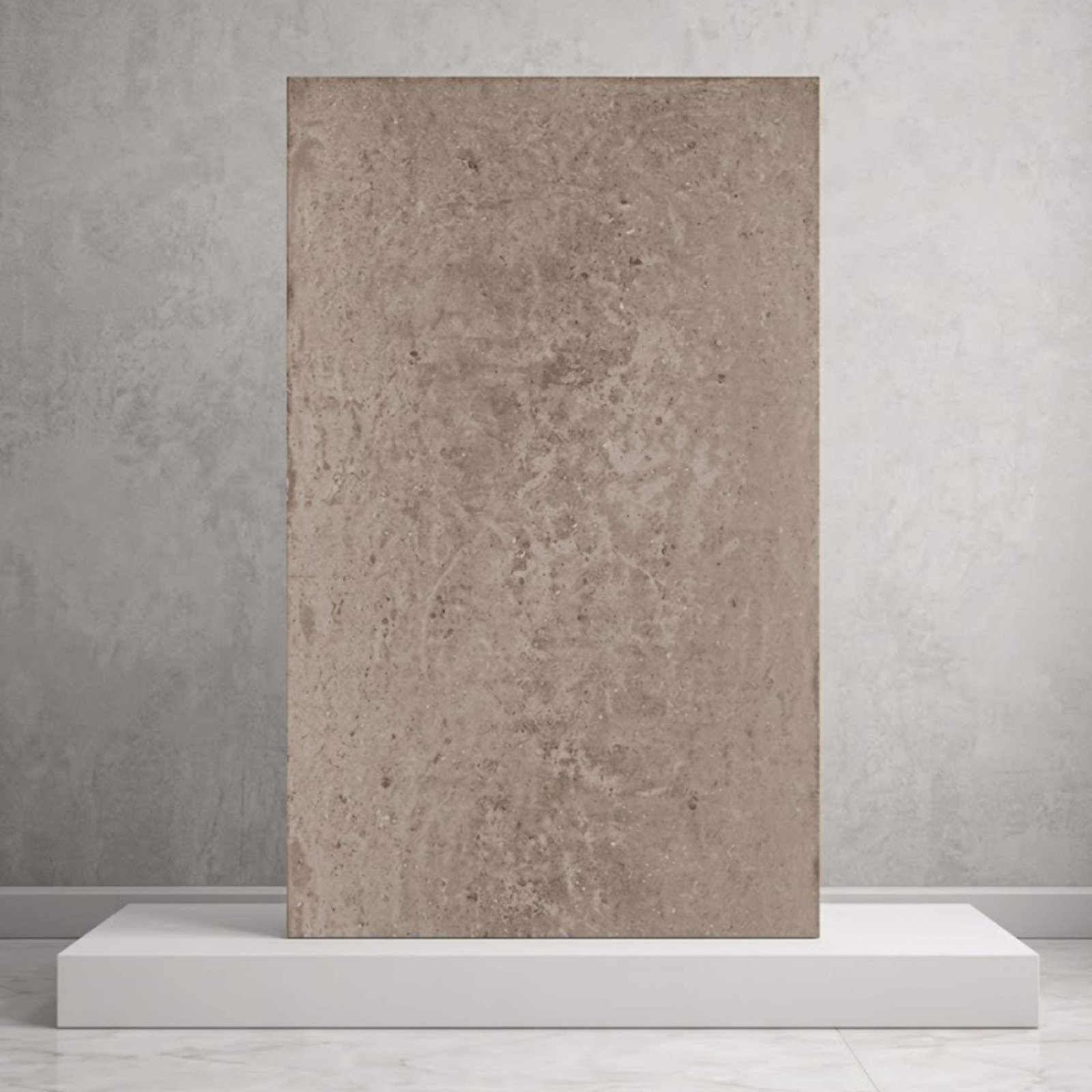 A large rectangular earthy taupe stone tile presented vertically on a white display block from alwakil.ae