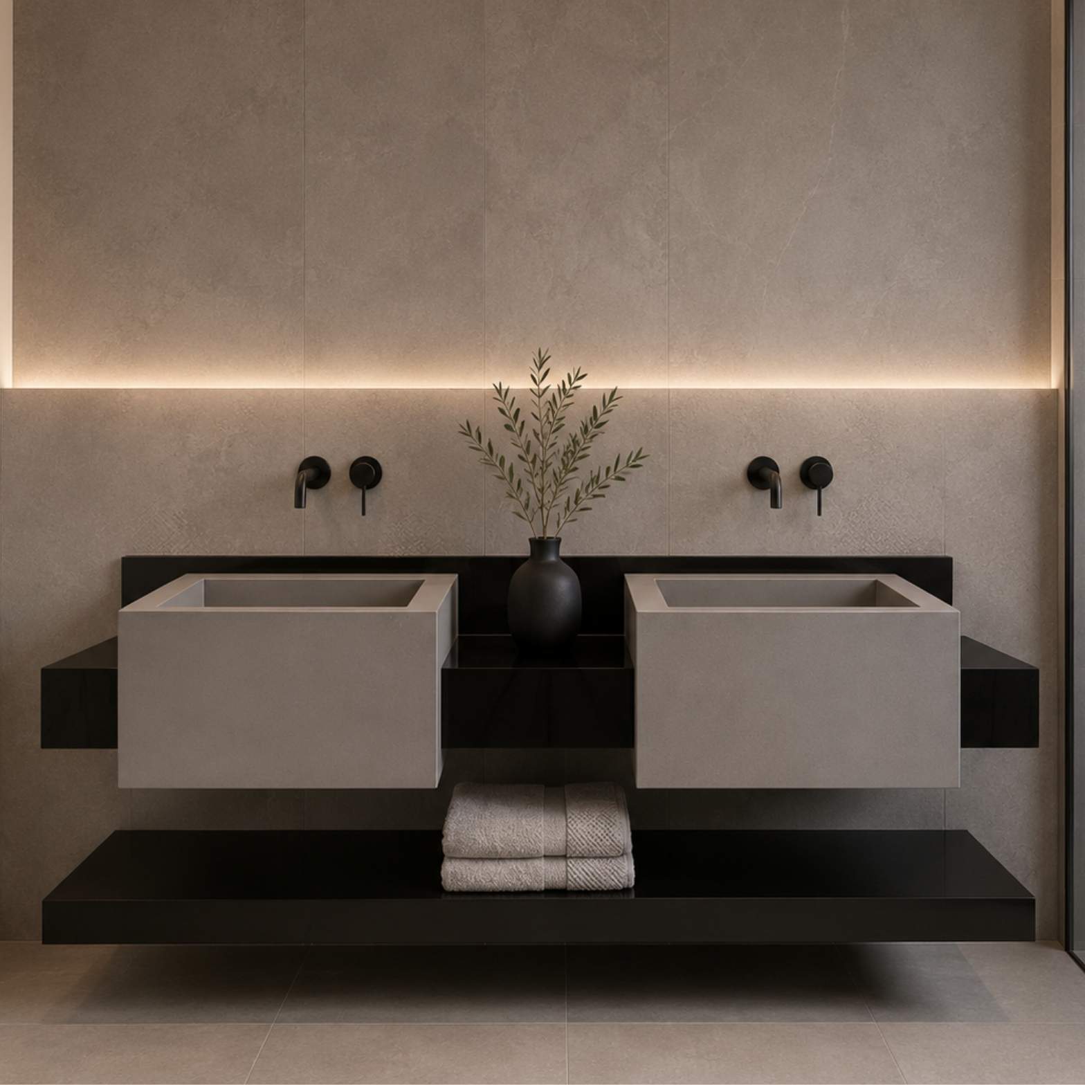 Two square gray concrete washbasins mounted on a floating black vanity with matte black wall faucets against a textured beige tile wall.