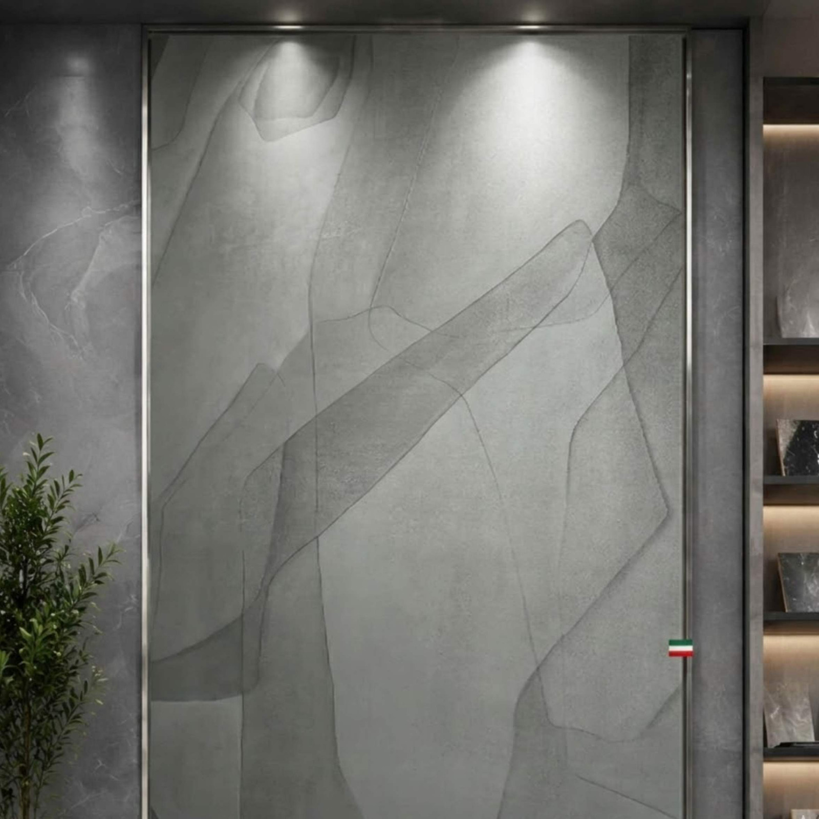 A full-height matte slate grey accent wall panel with minimalist abstract linework in a lit showroom from alwakil.ae