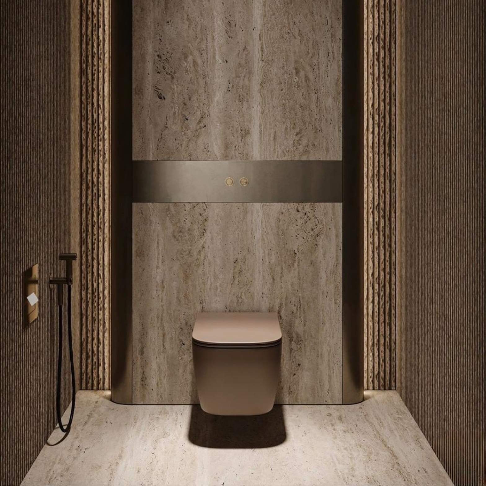 A sleek, modern wall-hung toilet in a matte earthy taupe color, centered on a textured beige travertine wall with embedded metallic flush buttons.